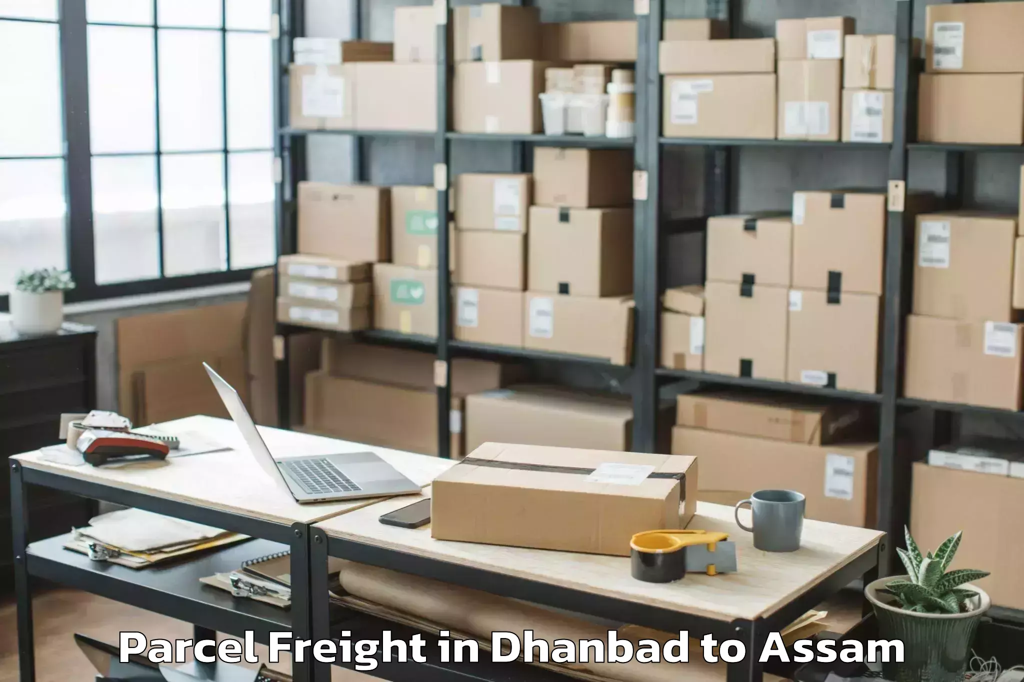 Book Dhanbad to Dhakuakhana Pt Parcel Freight Online